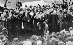 After the summit, British Prime Minister Neville Chamberlain returned to Great Britain where he declared that the Munich agreement meant 'peace for our time.'