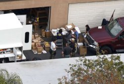 FBI investigators sort through contents of the garage of the suspects involved in the Wednesday attack seen in an aerial photo in Redlands, California, Dec. 3, 2015.