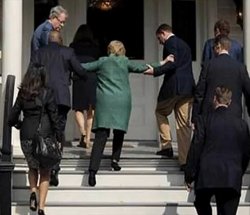 Hillary Clinton being helped up stairs