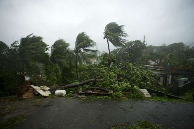 A picture taken on September 19, 2017 shows the powerful winds and rains of Hurricane Maria battering the city of Petit-Bourg on the Caribbean island of Guadeloupe.