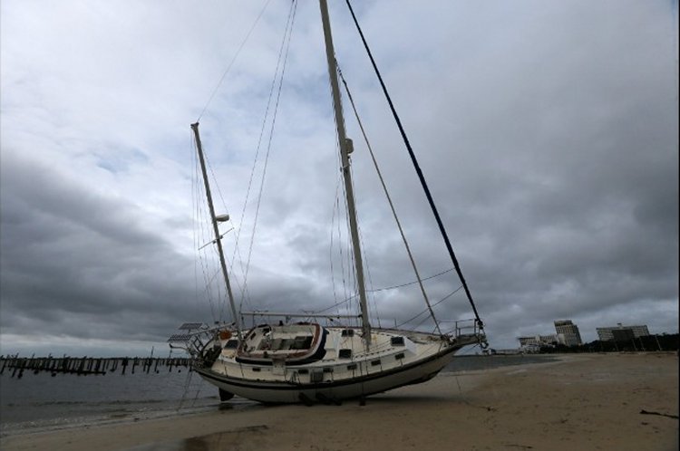 A sailboat is seen after it was washed ashore in Biloxi, Mississippi, during Hurricane Nate on Sunday, October 8, 2017.