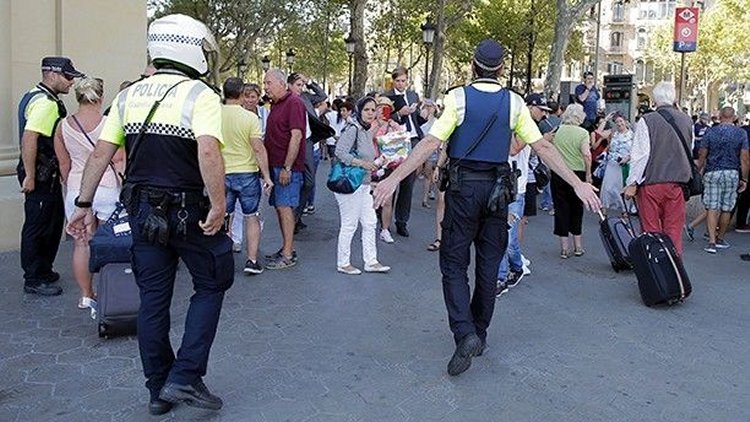 Police officers tell members of the public to leave the scene in a street in Barcelona, Spain, Thursday, Aug. 17, 2017  (AP Photo/Manu Fernandez)