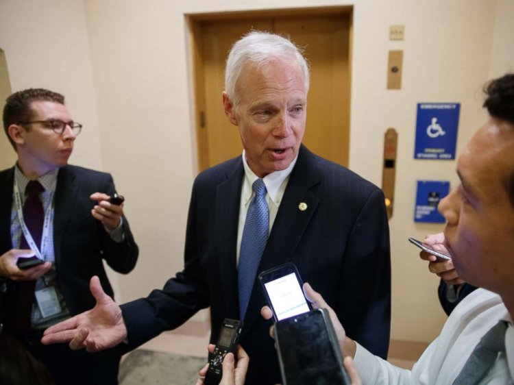 Sen. Ron Johnson, R-Wis. responds to reporters as he and other Senators arrive for weekly policy meetings on Capitol Hill in Washington, July 11, 2017.