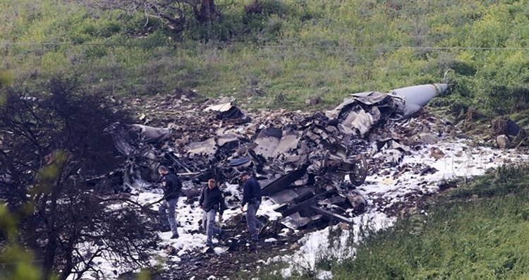 Investigators inspect the wreckage of an F-16 jet that crashed in northern Israel. (AP)