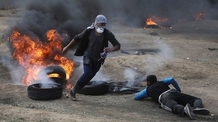 May 14, 2018: Palestinian protesters burn tires during a protest on the Gaza Strip's border with Israel. (AP)