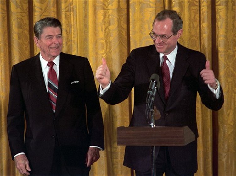 Supreme Court Justice Anthony Kennedy gives the thumbs-up after taking the constitutional oath at the White House on Feb. 18, 1988 as President Ronald Reagan looks on. Doug Mills / AP file