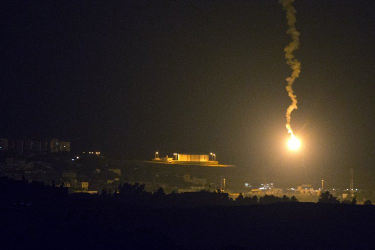 A picture taken from the southern Israeli border with the Gaza Strip shows Israeli flares illuminating the Palestinian coastal enclave, on July 7, 2014. (photo credit: AFP/JACK GUEZ)
