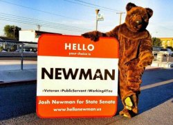 Josh Newman campaigning on a street corner in a bear suit
